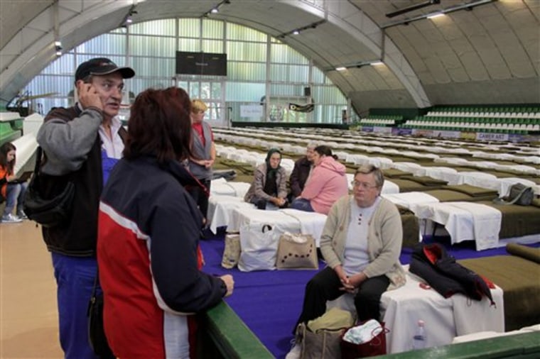 The first residents who were evacuated from toxic red sludge-hit Kolontar village arrive at the temporary shelter set up in the Sports Hall of Ajka, west of Budapest, Hungary, on Saturday. 